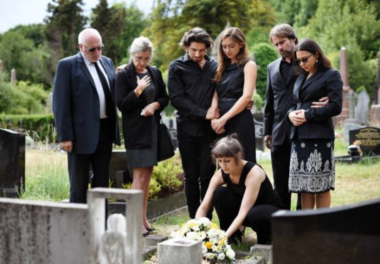 Family Laying A Wreath